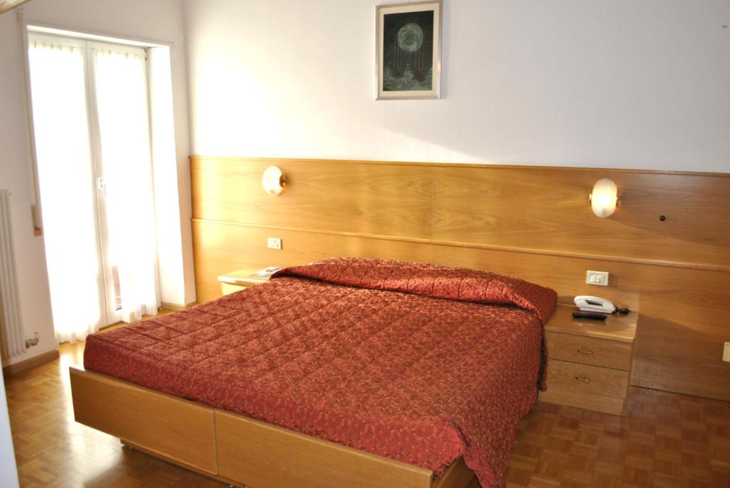 Postel nebo postele na pokoji v ubytování Hotel Zurigo
