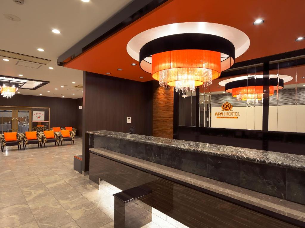 un vestíbulo de un restaurante con sillas naranjas en APA Hotel Gifu Hashima Ekimae en Hashima