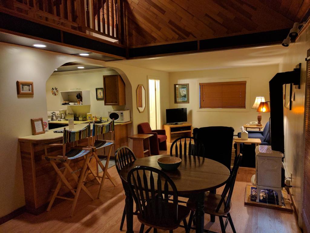 a kitchen and living room with a table and chairs at Chalet at Mt. Rainier in Ashford