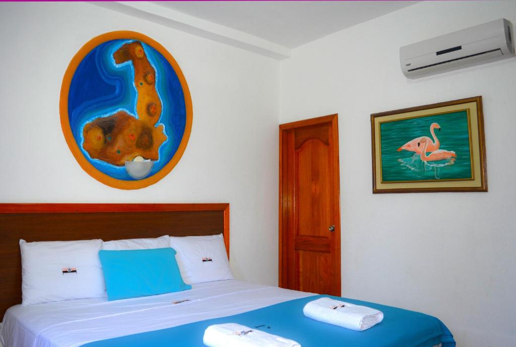 Postel nebo postele na pokoji v ubytování Hotel Coloma Galapagos