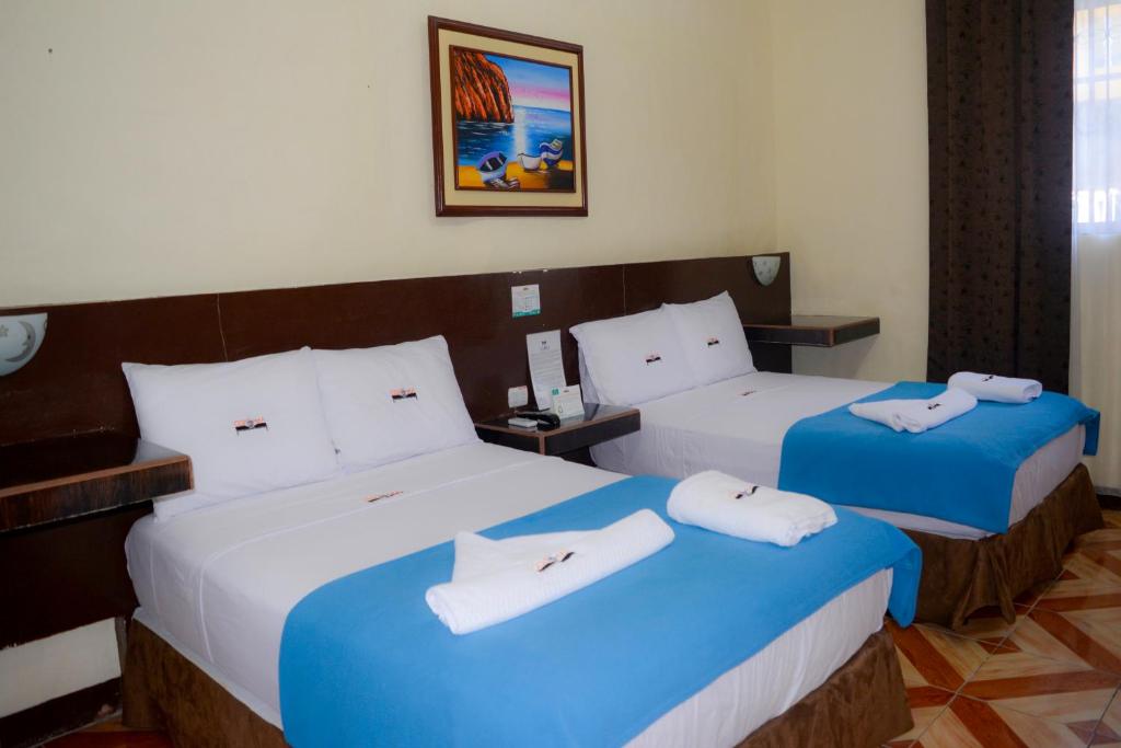 Postel nebo postele na pokoji v ubytování Hotel Coloma Galapagos