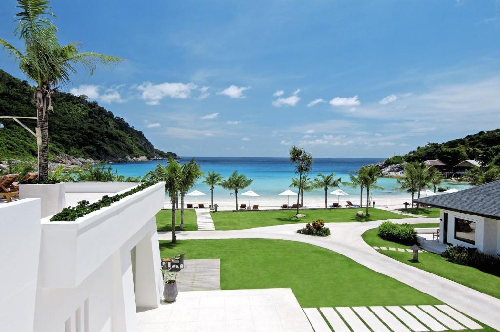 a view of the beach from the balcony of a resort at The Racha in Ko Racha Yai 