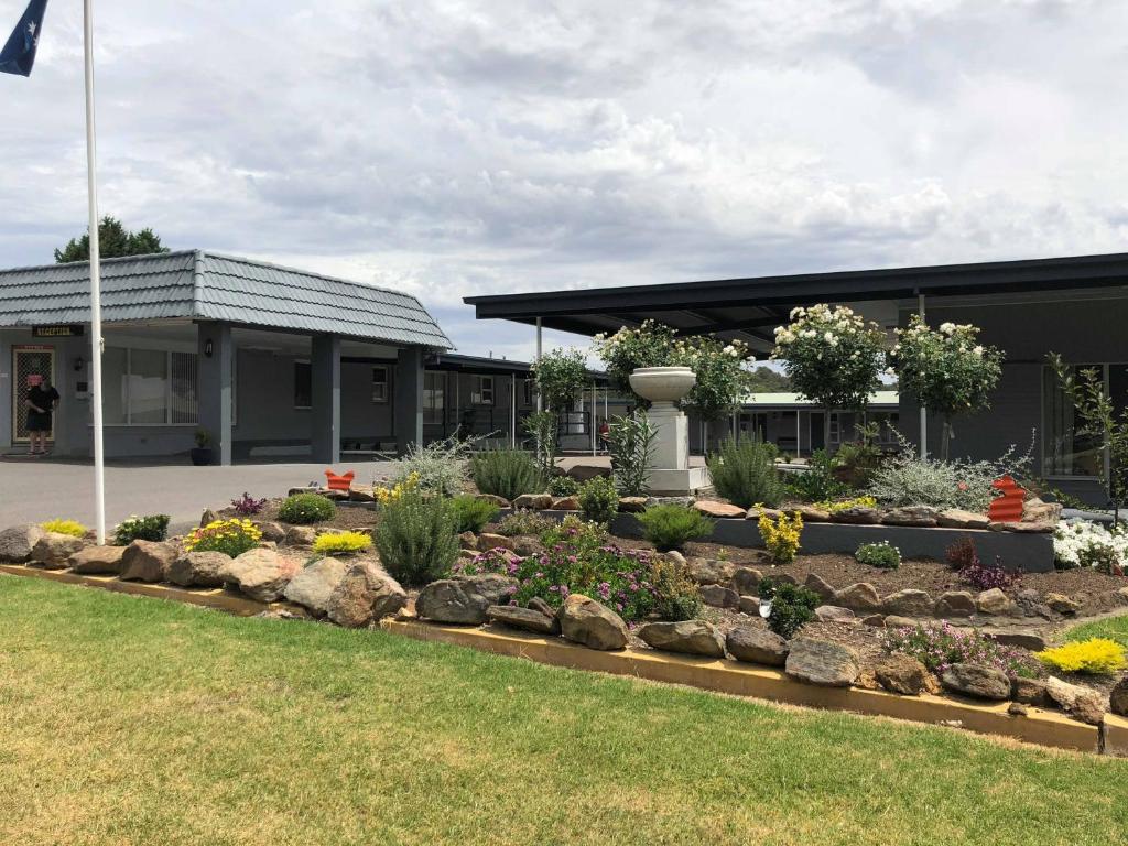 a garden in front of a building at Yass Motel in Yass