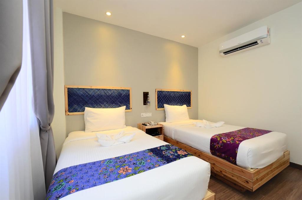 Postel nebo postele na pokoji v ubytování Artisan Eco Hotel