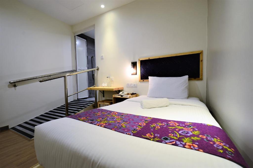 Postel nebo postele na pokoji v ubytování Artisan Eco Hotel