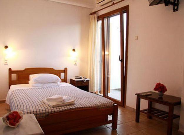 Postel nebo postele na pokoji v ubytování Artemon Hotel