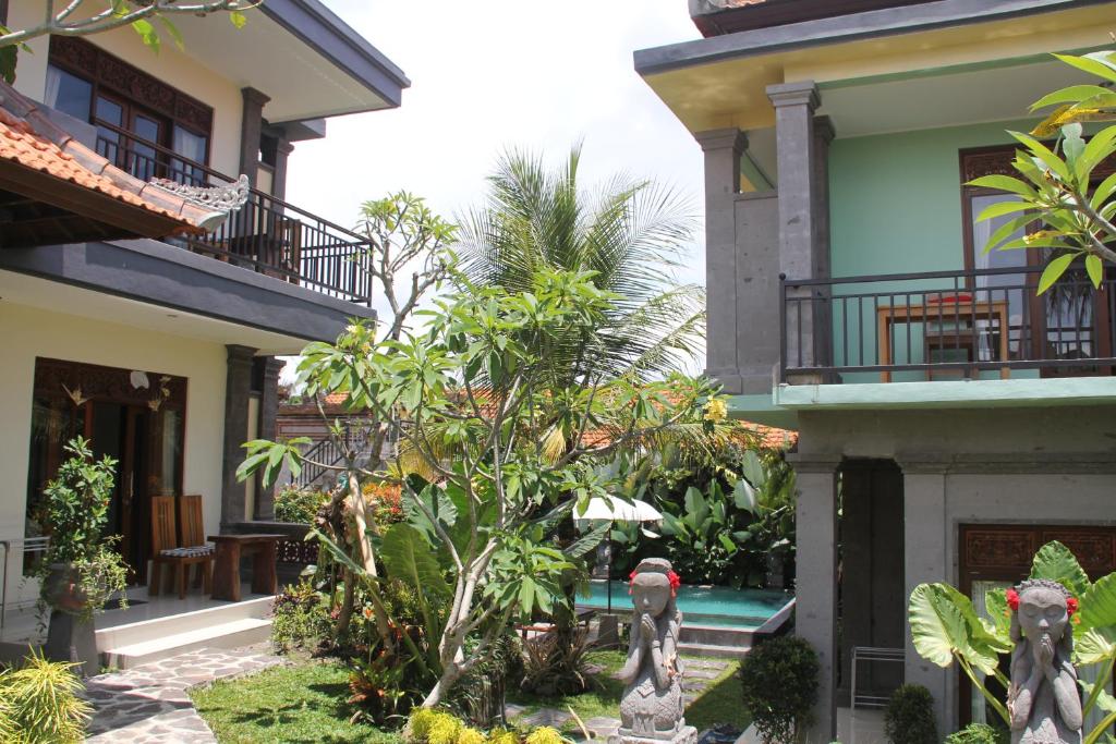 a courtyard of a house with a swimming pool at Villa Bungsil Gading in Ubud