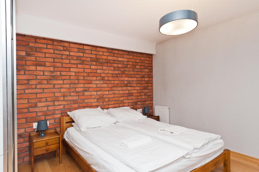 Posteľ alebo postele v izbe v ubytovaní Olimp Apartments