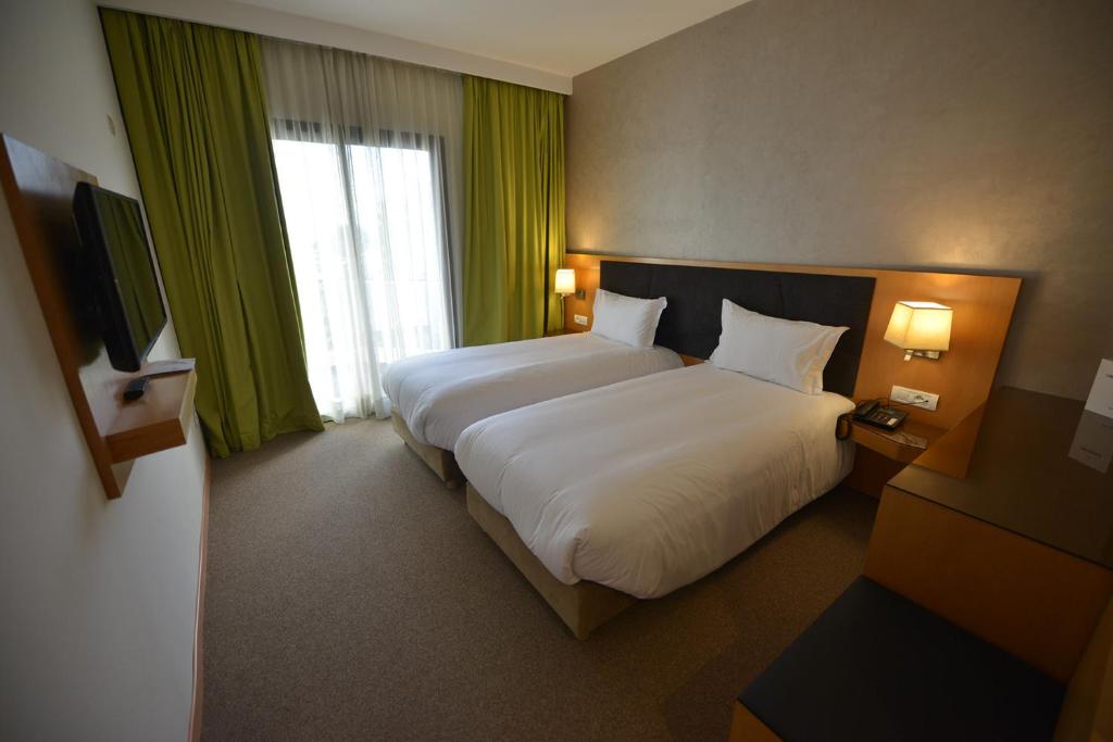 Postel nebo postele na pokoji v ubytování Annakhil Hotel