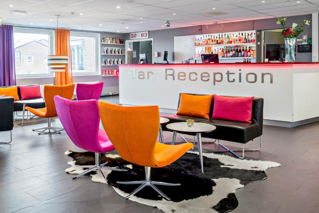 a store with colorful chairs and a bar at Sure Hotel by Best Western Stockholm Alvsjo in Stockholm