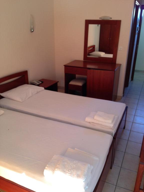 Postel nebo postele na pokoji v ubytování Hotel Akrogiali
