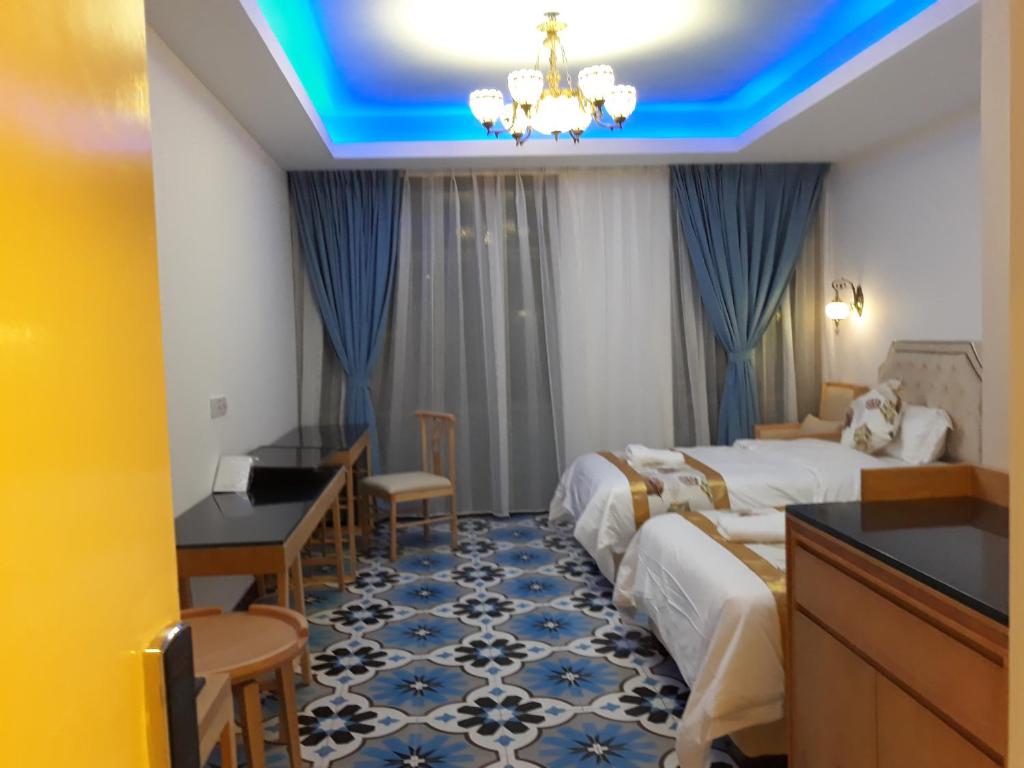 Postel nebo postele na pokoji v ubytování Hotel Hilal