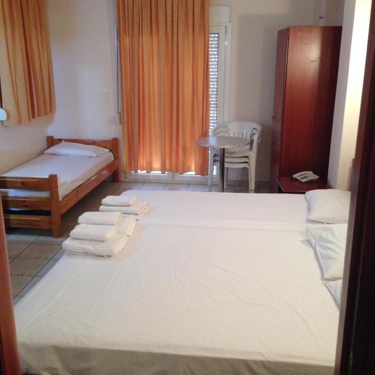 Postel nebo postele na pokoji v ubytování Hotel Akrogiali