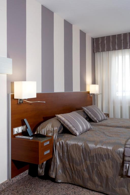 Postel nebo postele na pokoji v ubytování Hotel Marivella