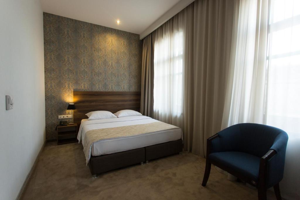 Postel nebo postele na pokoji v ubytování Old Meidan Tbilisi By Urban Hotels