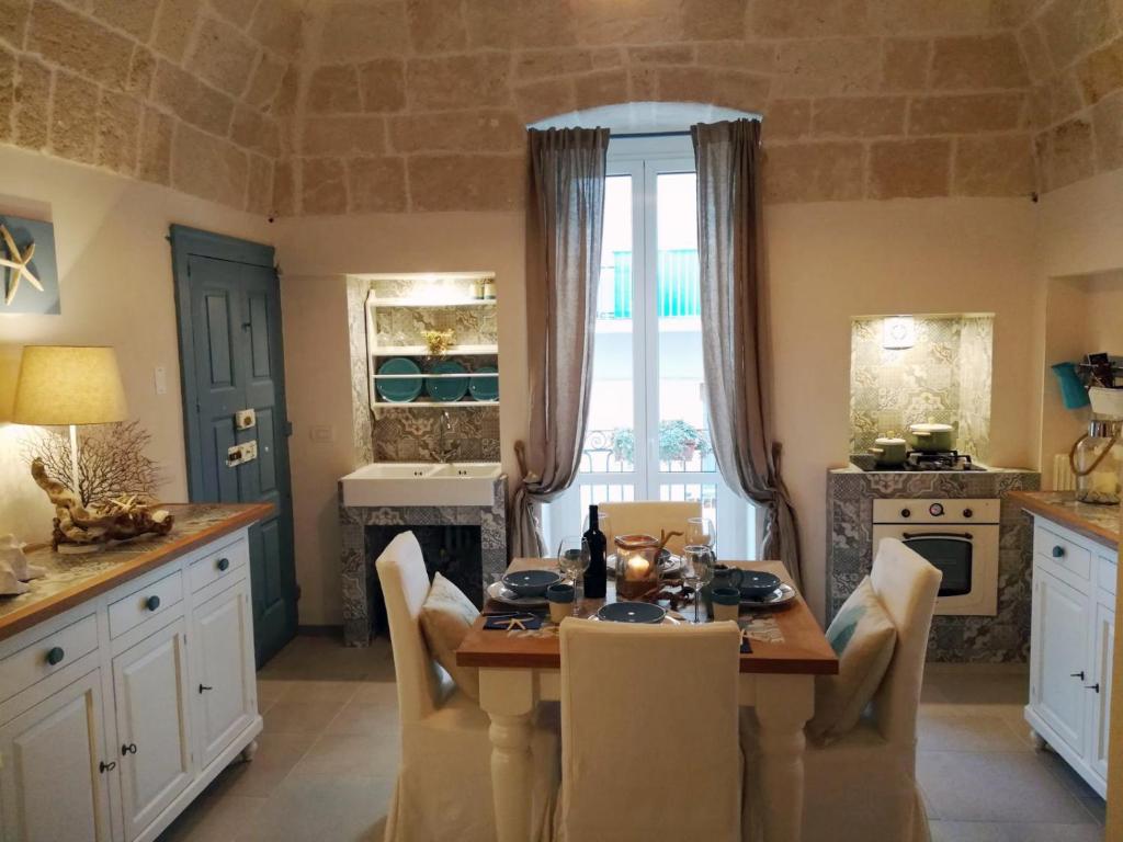 a kitchen with a table with chairs and a dining room at Casa Carlotta in Monopoli