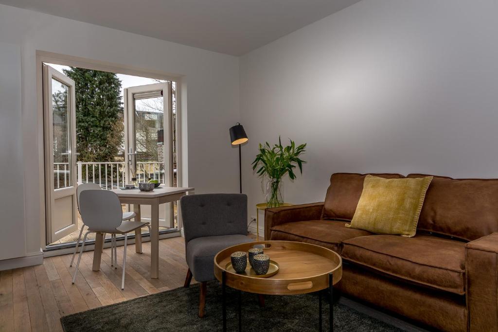 a living room with a couch and a table at Zoet Valkenburg in Valkenburg