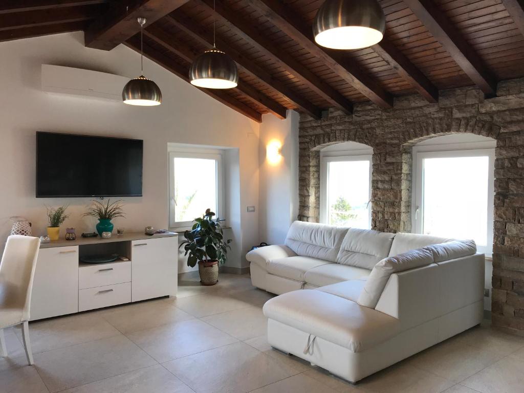 a living room with a couch and a tv at Casa Isabelle in La Spezia