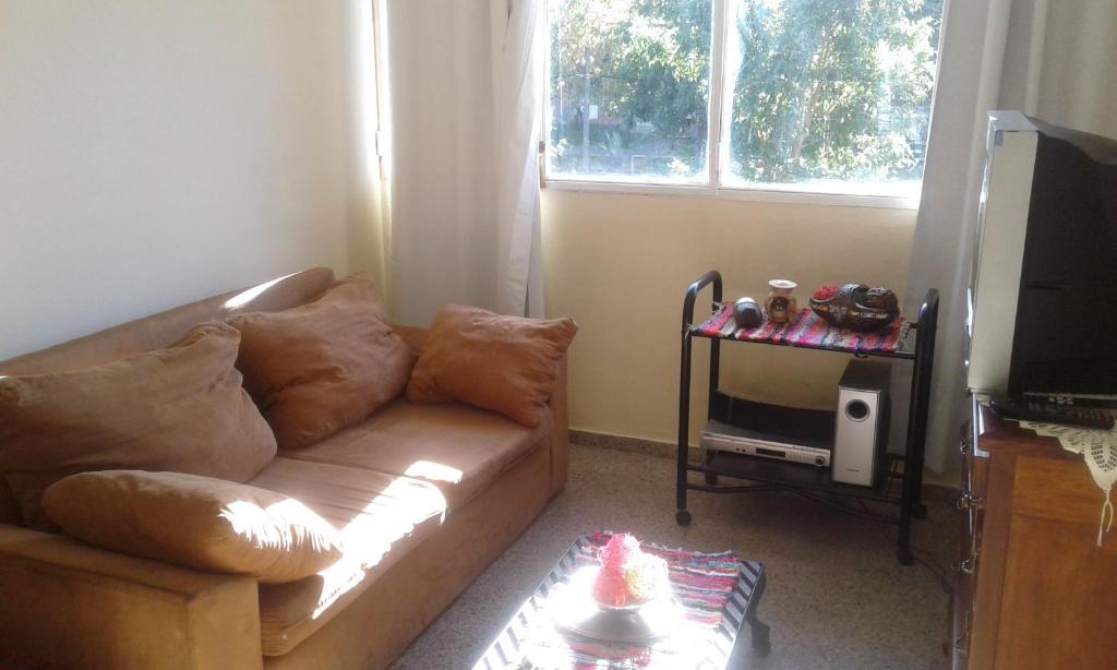 a living room with a couch and a television at Leohome in Melo