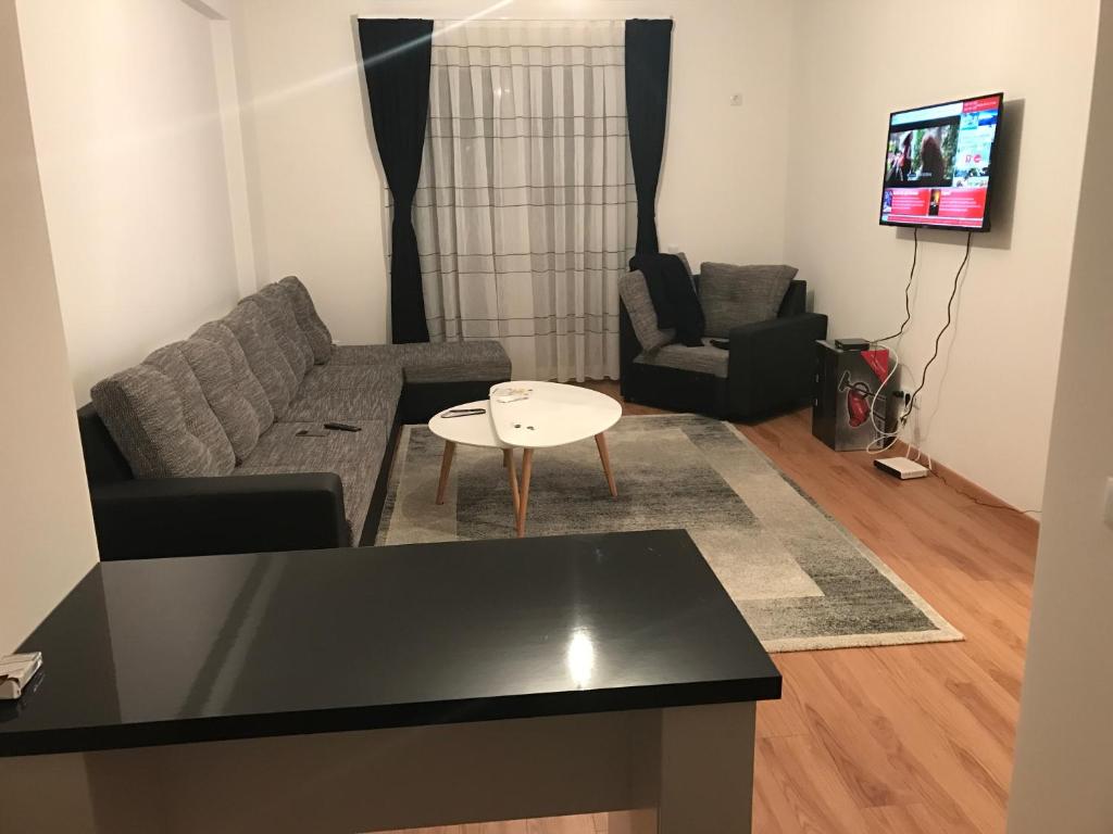 a living room with a couch and a table at 1 Bedroom flat in Kosovo Polje
