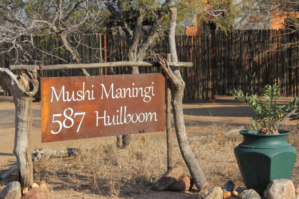 a sign for a museum with a plant next to it at Mushi Maningi in Hoedspruit