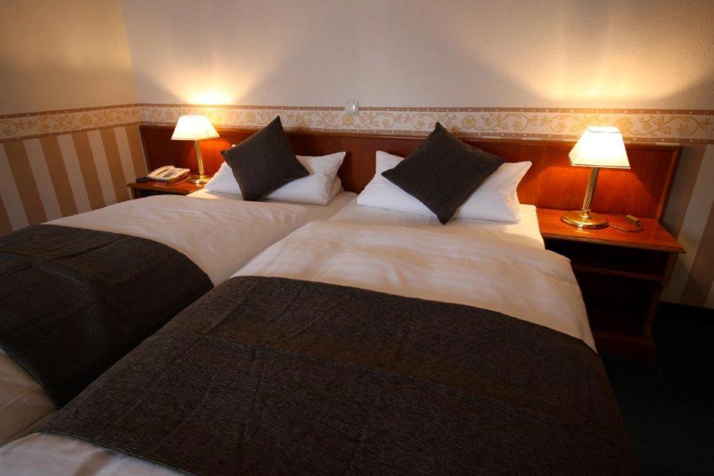 Postel nebo postele na pokoji v ubytování Hotel Burg-Mühle