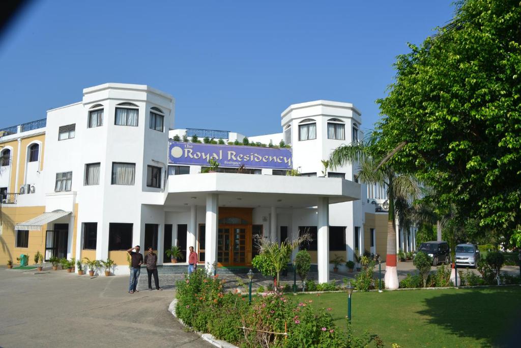 a white building with a sign that reads royal hospital at The Royal Residency in Bodh Gaya