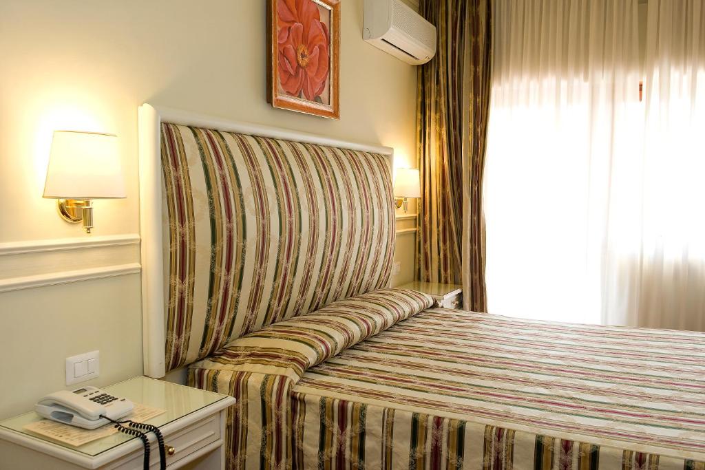 Voodi või voodid majutusasutuse Park Hotel Villaferrata toas