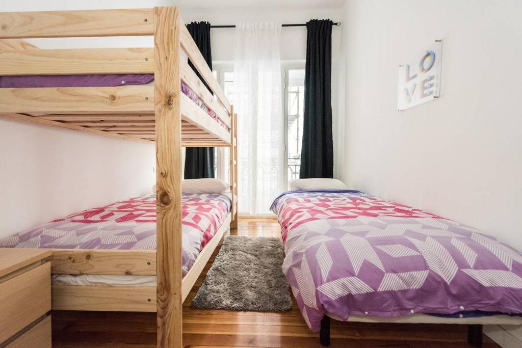 Postel nebo postele na pokoji v ubytování M&F Gran Via 3 Hab