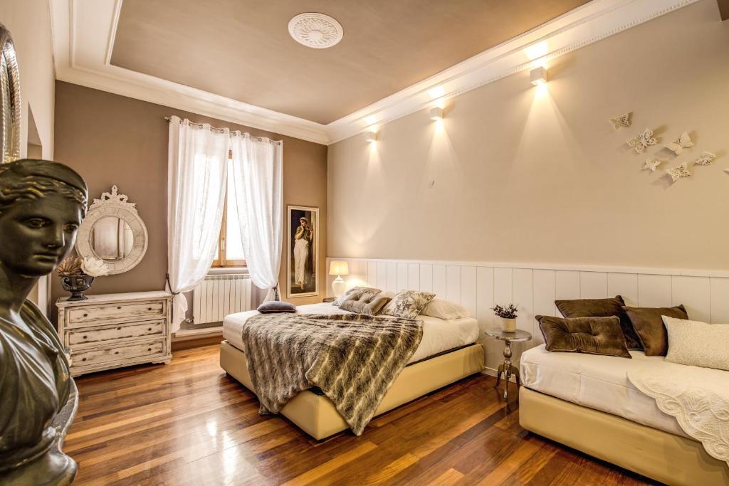 a bedroom with two beds and a statue in it at Spanish Steps Miracle Suite in Rome