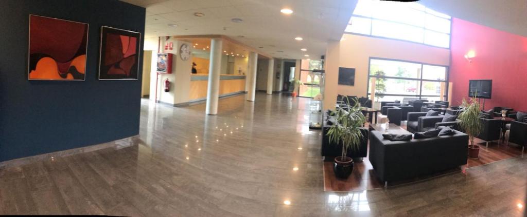 a lobby with couches and chairs in a building at Hotel Les Torres in Martorell