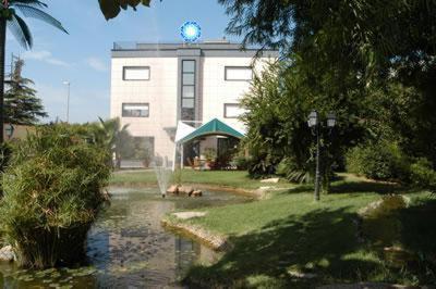 a large building with a clock on the top of it at Hotel Ottagono in Andria