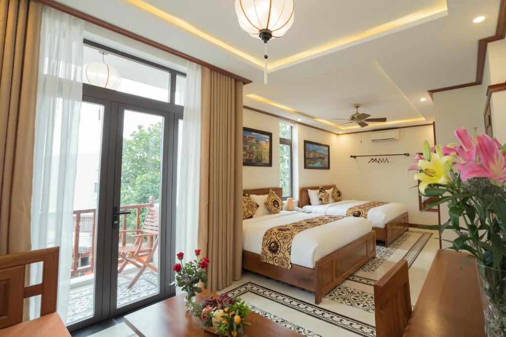 Postel nebo postele na pokoji v ubytování Hoi An Discovery Villa