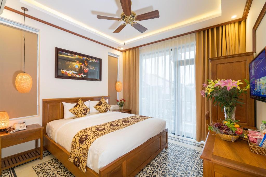 Postel nebo postele na pokoji v ubytování Hoi An Discovery Villa