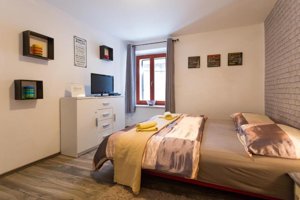 a bedroom with two beds and a television in it at Apartment Antonio in Split
