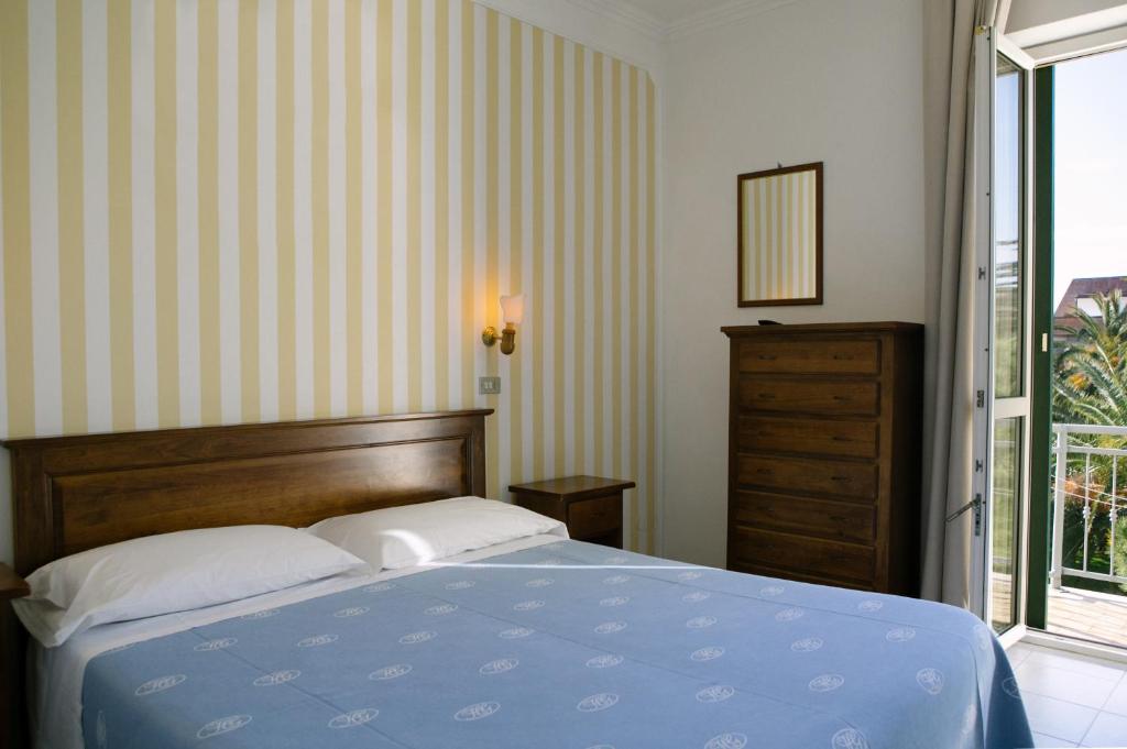 Postel nebo postele na pokoji v ubytování Hotel Giardino