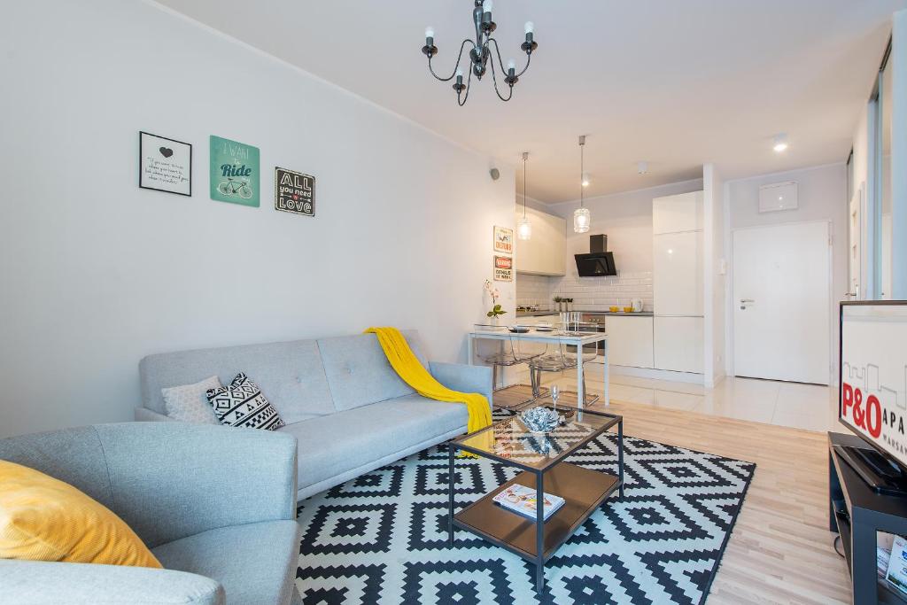 a living room with a blue couch and a table at Mokotow in Warsaw