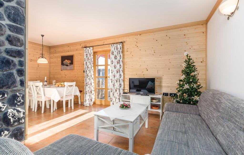 a living room with a couch and a table with a christmas tree at Apartment Vila Lokve in Lokve