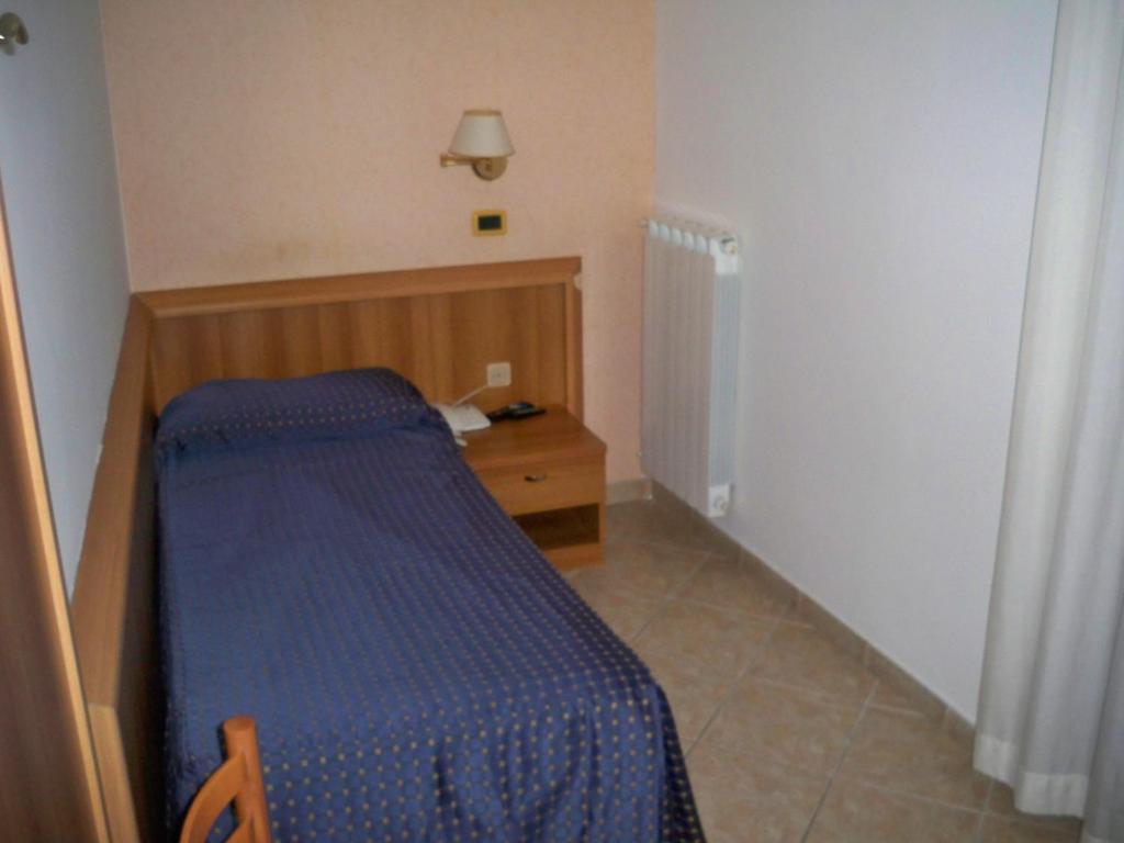 Łóżko lub łóżka w pokoju w obiekcie Albergo Corradetti
