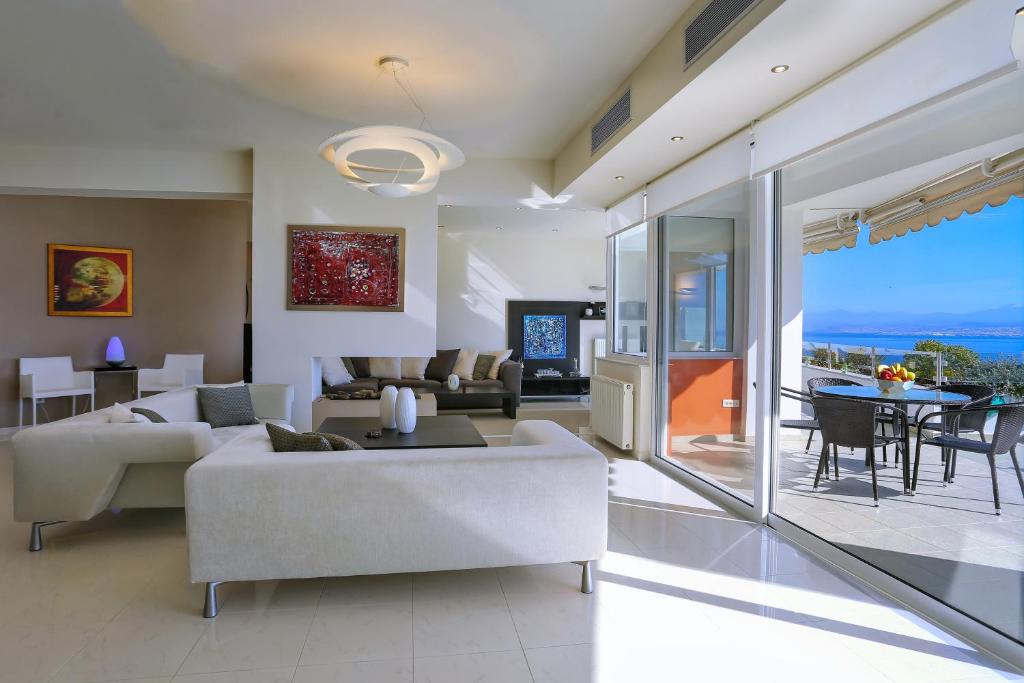 a living room with a couch and a table at Antiopi Luxury Villa in Agia Pelagia