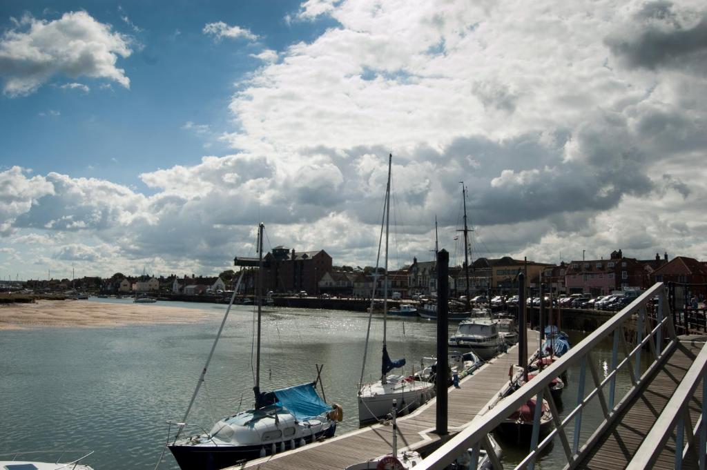 a group of boats docked at a dock in the water at YHA Wells-next-the-Sea in Wells next the Sea