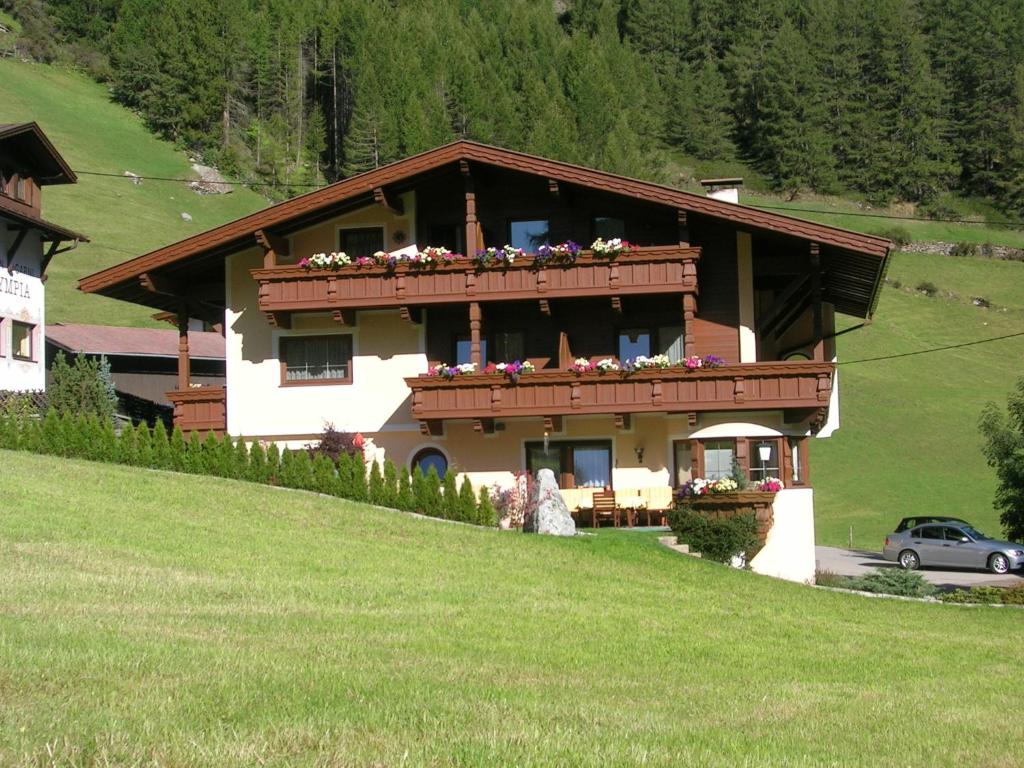 a house with a balcony with flowers on it at Haus Marcell in Sölden
