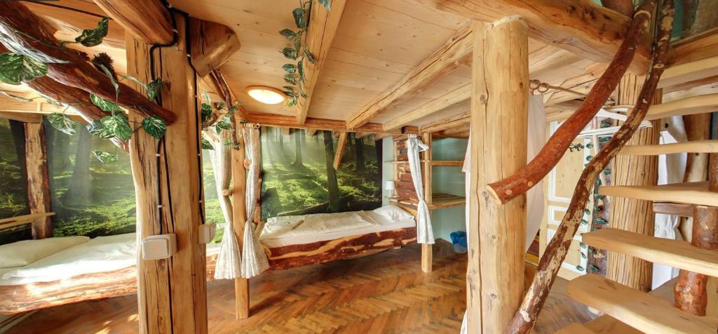 a bedroom with a wooden bed and a wooden roof at Artharmony Pension & Hostel in Prague