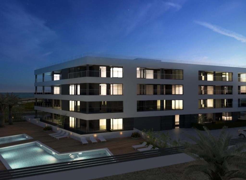 a rendering of a building with a swimming pool at Apartament Orhidea in La Mata