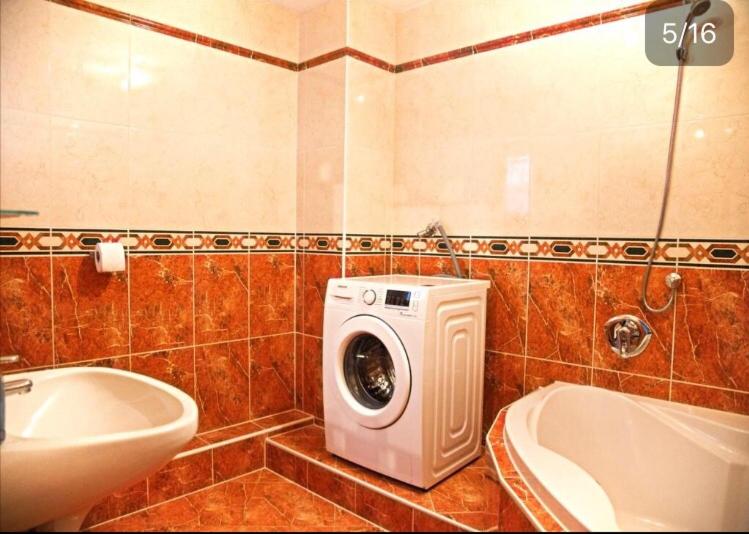 a bathroom with a washing machine and a sink at Ferienhaus Nathalie Leser in Baden-Baden