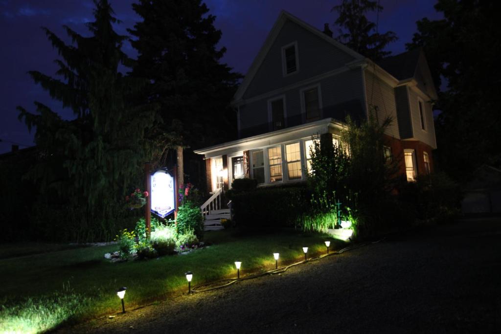 a house with lights in the yard at night at Ambiance By The Falls B&B in Niagara Falls