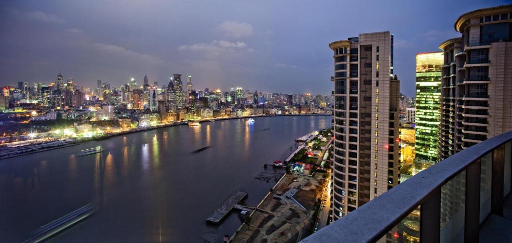 a view of a river in a city at night at Fraser Suites Top Glory Shanghai in Shanghai