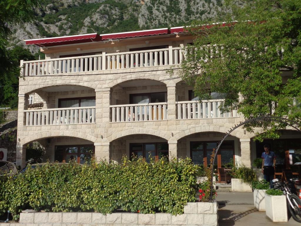a building with a balcony on top of it at Apartments Bella di Mare in Kotor