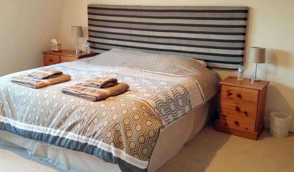 a bedroom with a bed with two towels on it at Southcote in Weston-super-Mare