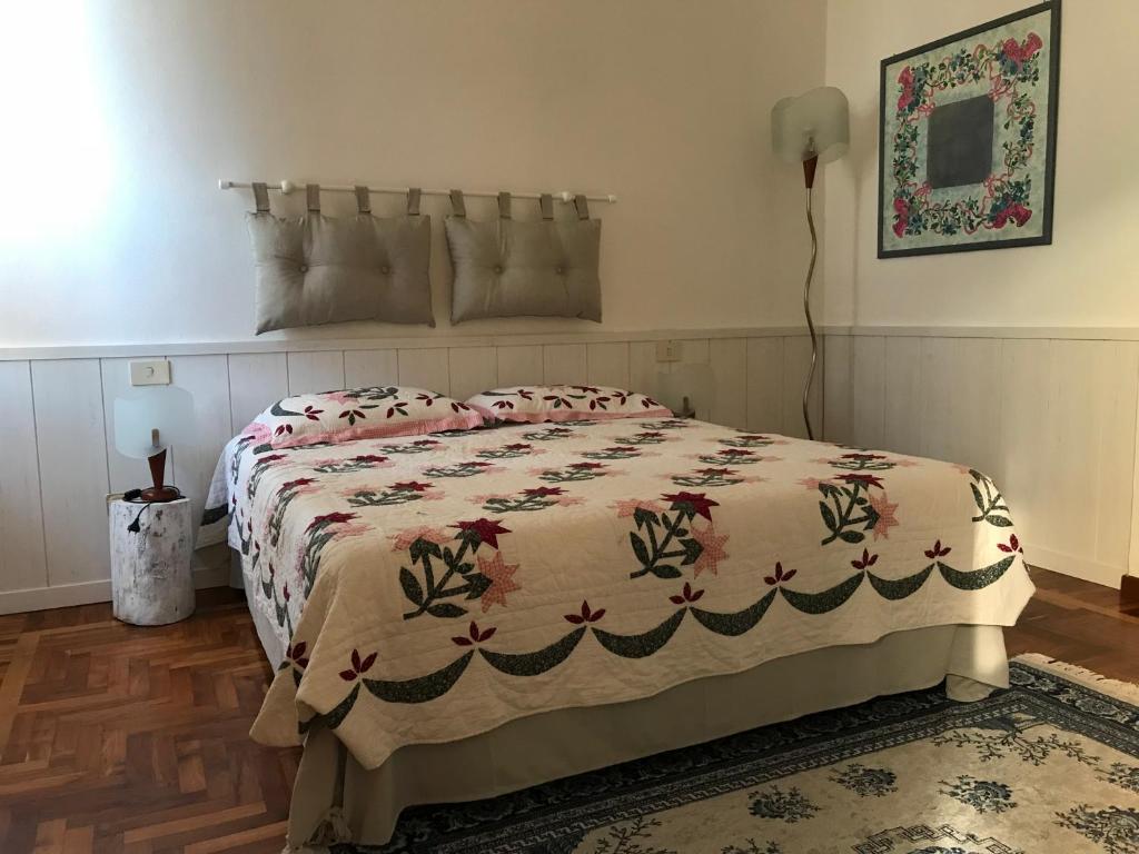 a bedroom with a bed with a comforter on it at Agli acquedotti romani in Rome